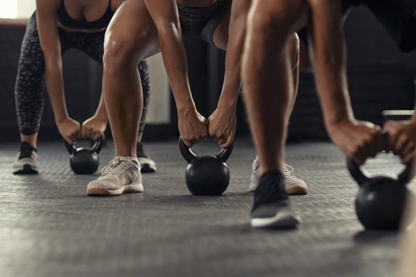 Fitness people hands lifting kettle bell